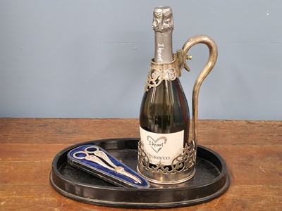 Lot 1790 - An antique silver-plated wine bottle cradle...