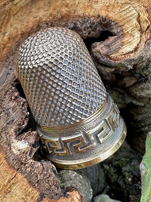 Lot 1142 - A gold thimble of tapering form, decorated...