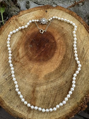 Lot 1145 - A graduated single-row pearl necklace, the...