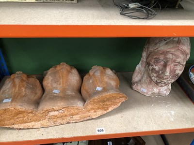 Lot 509 - A terracotta group of three cats' heads...