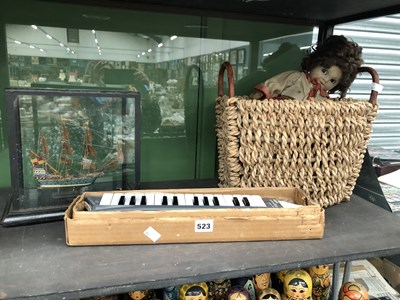 Lot 523 - A glazed cased three masted war ship, a basket,...