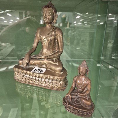 Lot 535 - A Tibetan style polished bronze Budda on a...