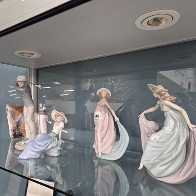 Lot 546 - A Lladro golfer and three figures of ladies