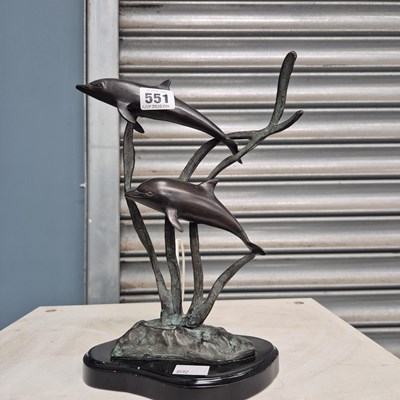Lot 551 - A bronze group of two dolphins swimming...