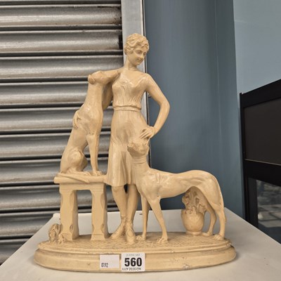 Lot 560 - An Art Deco white composition group of a lady...