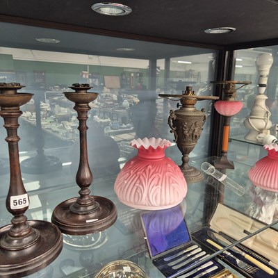 Lot 565 - Two oil lamps with frosted pink glass shades...