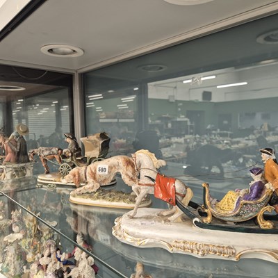 Lot 580 - A porcelain horse drawn sleigh group, a...
