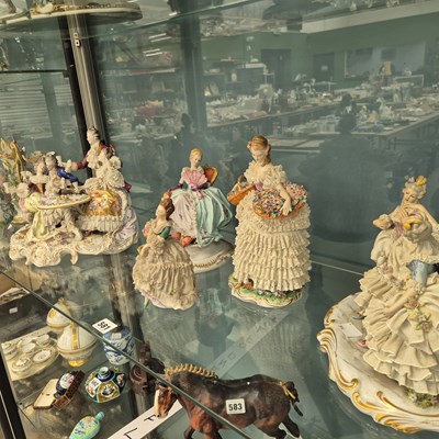 Lot 581 - A group of figures with lace trimmed clothing,...