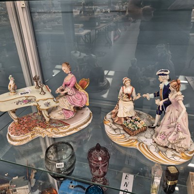 Lot 600 - A Capodimonte lady playing a piano together...