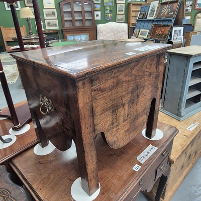 Lot 128 - A Georgian oak lift top stool with a shaped...
