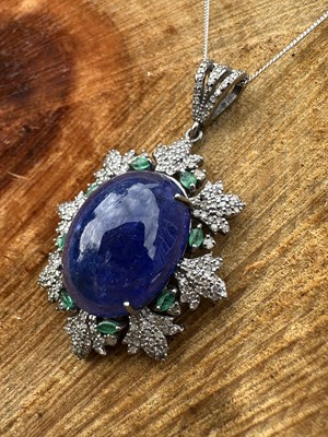 Lot 1197 - A large silver oval cabochon tanzanite,...