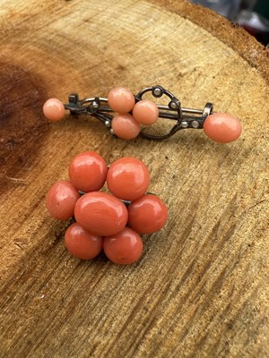 Lot 1181 - Two antique brooches; a coral cluster brooch...
