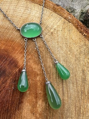Lot 1108 - An antique necklace, set with an oval green...