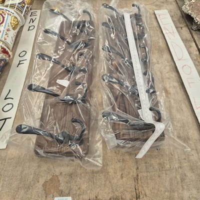 Lot 672 - Two wooden backed rows of five iron coat hooks