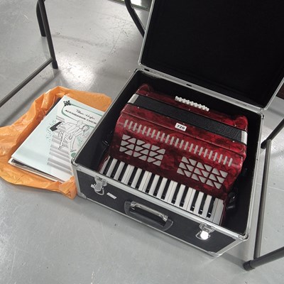 Lot 720 - A cased piano accordion, together with a...