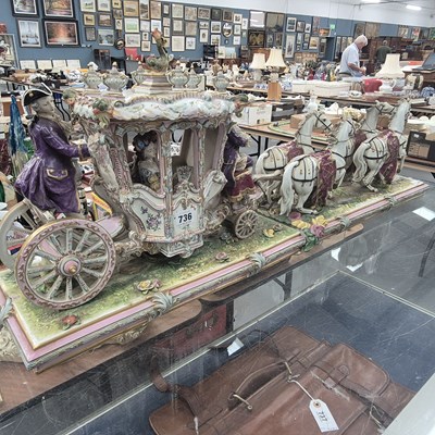 Lot 736 - A European porcelain four horse drawn carriage....