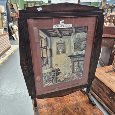 Lot 184 - A early 1900s fire screen set with a needwork...