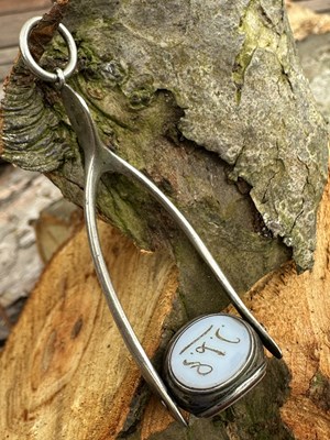 Lot 1164 - A silver rotating triple-seal fob suspended...