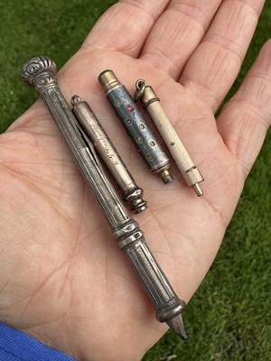 Lot 1015 - One large silver propelling pencil and three...