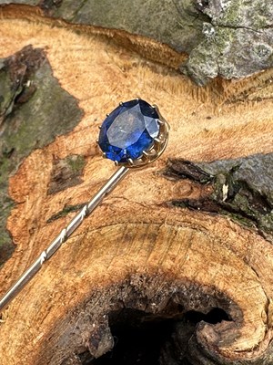 Lot 1154 - A late 19th century sapphire stick pin, the...