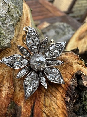 Lot 1114 - A Victorian diamond flowerhead brooch pendant,...