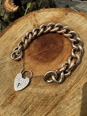 Lot 1212 - A 9ct rose gold charm bracelet formed of...