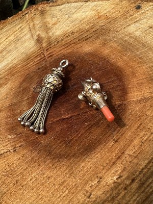 Lot 1221 - Two pendants, comprising a novelty miniature...