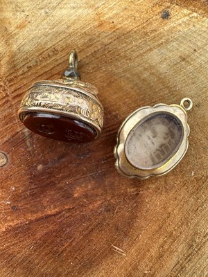 Lot 1223 - An antique gold seal fob with a carnelian face...