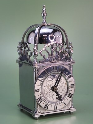 Lot 1536 - A chrome cased miniature lantern clock with a...