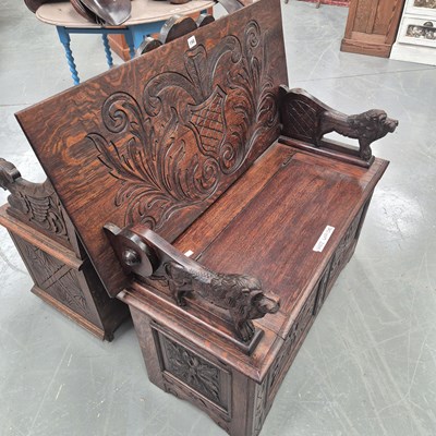 Lot 198 - A carved oak monk's bench with lion figure...