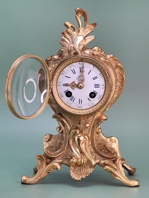 Lot 1544 - A French Rococo ormolu mantle clock striking...