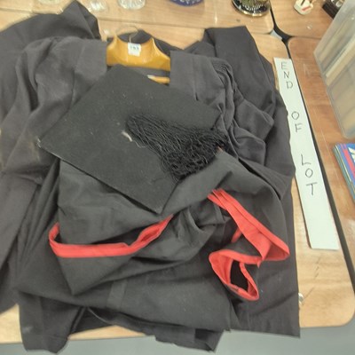 Lot 793 - An academic gown, red and black hood, trousers...