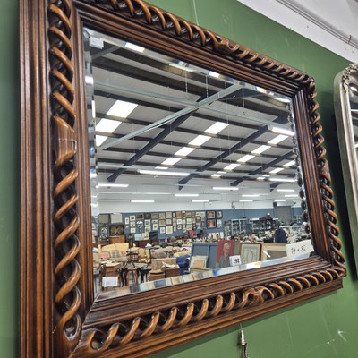 Lot 292 - A wood framed mirror with double helix detail...