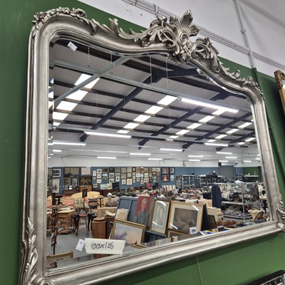 Lot 294 - An ornate silver painted overmantle mirror 100...