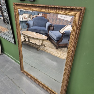 Lot 298 - A gilt mirror with a ridged swept frame 136 ×...