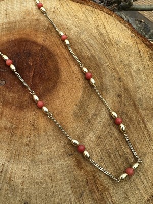 Lot 1242 - A 9ct gold and coral necklace, spaced with...