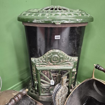 Lot 1808 - An antique cast iron and green enamelled solid...