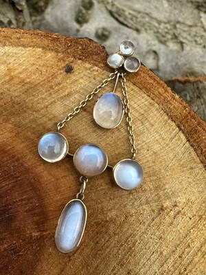 Lot 1149 - An Art Nouveau Moonstone pendant set with...