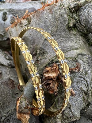 Lot 1257 - A pair of Indian yellow gold bangles of...
