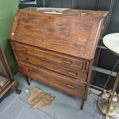 Lot 309 - A 20th century oak bureau of three drawers on...