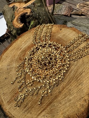 Lot 1251 - An impressive Indian yellow metal bib necklace,...