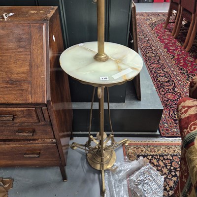 Lot 310 - A brass and onyx standard lamp with an...