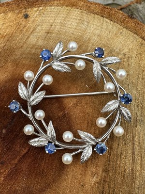 Lot 1253 - A vintage sapphire and pearl wreath brooch,...