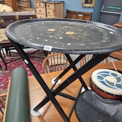 Lot 202 - An antique paper mache tray on a later stand