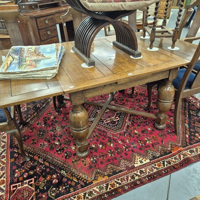 Lot 221 - An early 20th century oak draw leaf table on...