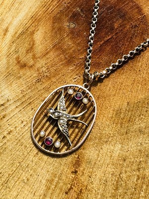 Lot 1007 - An Edwardian swallow pendant necklace, the...