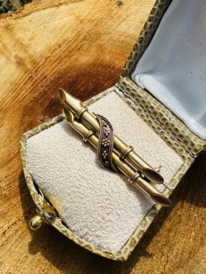 Lot 1034 - An Edwardian bamboo form brooch, the crossed...