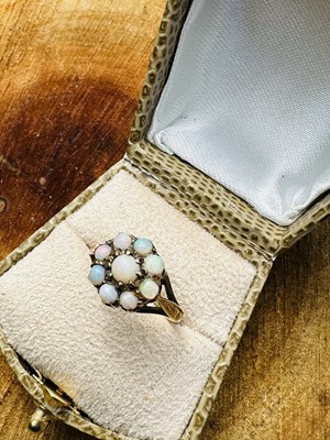 Lot 1056 - A vintage opal cluster ring, the central opal...