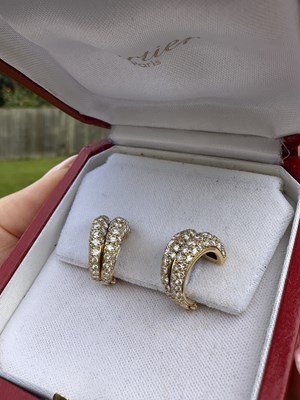 Lot 1058 - A pair of Cartier diamond set clip earrings,...
