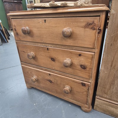 Lot 229 - A small Victorian pine chest of three draws on...